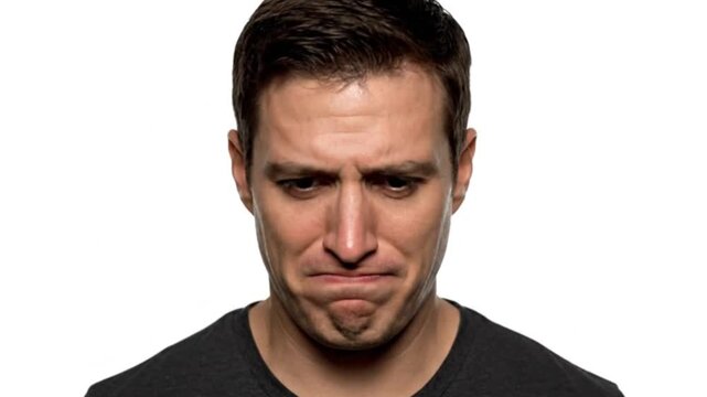 Close-up portrait of a man with a serious expression on a plain white background.