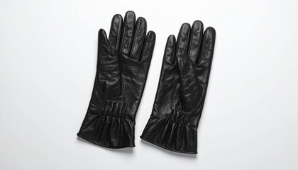A pair of black leather gloves with gathered wrists rests on a white surface—evoking tactile elegance, protective form, and the quiet symbolism of winter fashion and human gesture.