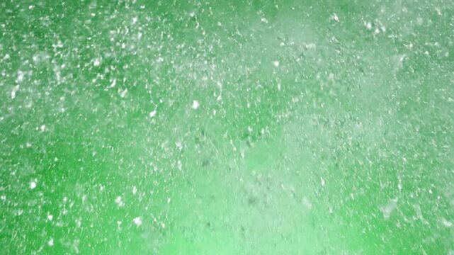 A brittle bottle disintegrates into a cloud of fine, dust-like glass particles, isolated on a pure green background unpredictable, vaporize, pure green background