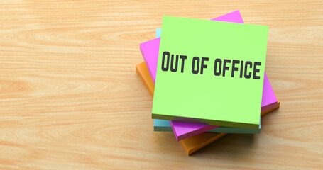Out of office text on colorful sticky note on wooden desk, business absence reminder concept.