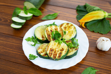 Close-up of grilled zucchini slices on dark wooden background