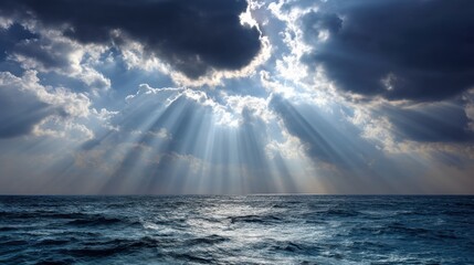 Sun rays breaking through dark storm clouds over ocean horizon during daytime