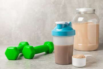 Protein shake with protein powder on a colored background. The powder is mixed with water or milk....
