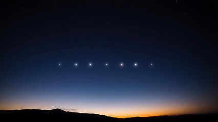 Obraz premium Six bright points of light aligned in the twilight sky above a dark, silhouetted horizon.