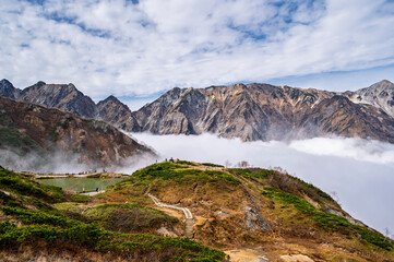 Hiking Route to Happo Pond and  the Japanese Alps mountains landscape with mist background on Hakuba Happo One in Hakuba, Nagano, Japan