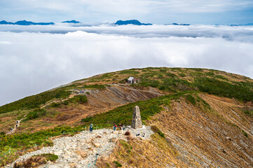 Hiking Route to Happo Pond and  the Japanese Alps mountains landscape with mist background on Hakuba Happo One in Hakuba, Nagano, Japan