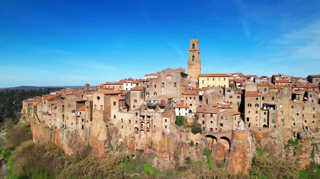 Italy Pitigliano 4k drone footage of medieval town on tuff rocks. Scenic landscape in Grosseto Tuscany. Authentic hilltop village architecture and ancient stone canyon