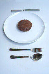 Small chocolate muffin, lava cake arranged on table