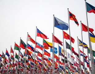 Obraz premium Colorful national flags waving against a bright sky international countries