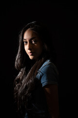 Young woman posing in low key lighting portrait