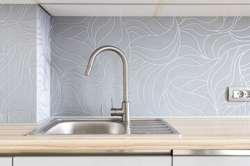 Fototapeta premium kitchen faucet on a stylish metal sink