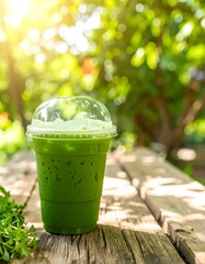 Iced green drink on wooden table outdoors