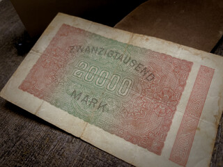 Reverse view of Germany vintage banknote from 1923, worth twenty thousand reichsmarks, displayed dramatically on a dark surface. Suitable for historical and financial designs.