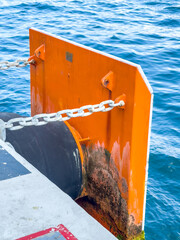 Protective board and mooring rope at the pier by the sea