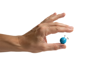 Hand holds small blue molecular model against white backdrop, showcasing scientific concept with precision and clarity.
