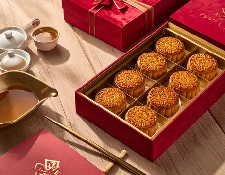 Premium mooncakes in velvet-lined box with golden festive accents and soft lighting.