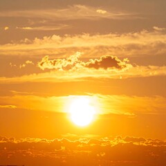 Golden sunset sky with clouds