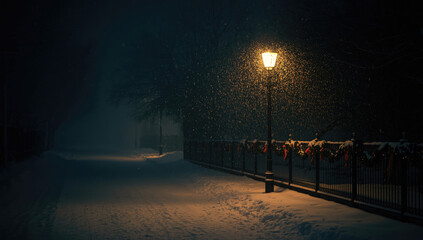 a street lamp on a snowy street at night