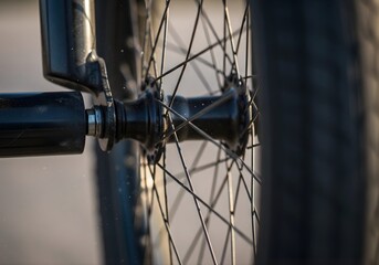 Dynamic panning close shot of spinning wheel with dust and rim highlights