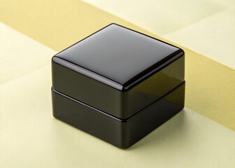 Premium glossy black cube on pastel yellow background