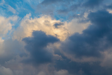 Sunlight reflects the texture of clouds high in the sky.
