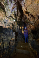 Woman photographing inside cave