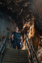 Fototapeta premium Tourist exploring limestone cave