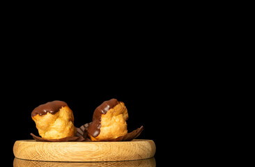 Chocolate sweet eclair, macro, isolated on black  background.