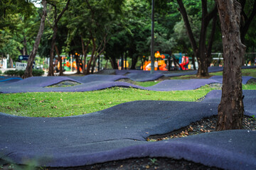 cushioned path for kids cycling or skating in park, soft track for children riding scooters or bikes and bicycle in safe playground area