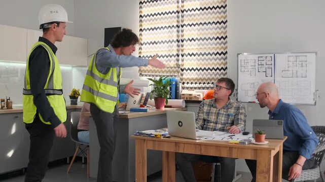 Two construction workers in reflective vests hold blueprints and argue with architect and manager sitting at desk. Heated discussion with gestures about building processes and project approvals.