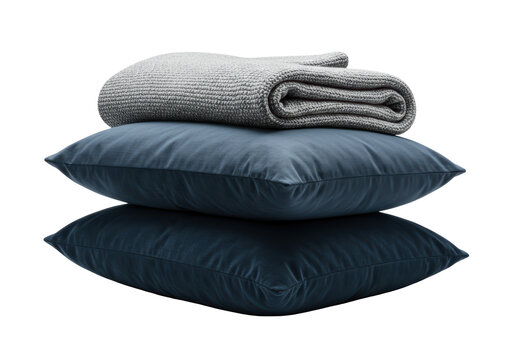 Isolated stack of dark pillows and a folded knitted blanket for the bed or sofa decor