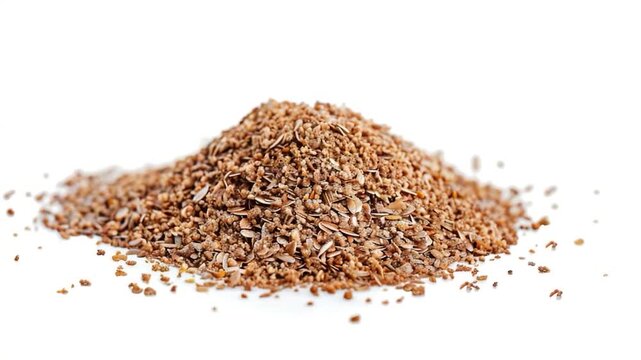 A pile of flax seeds on a white surface, ideal for food or craft projects