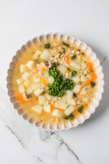 Delicious canned salmon fish soup with potatoes and parsley. Healthy food, recipes.