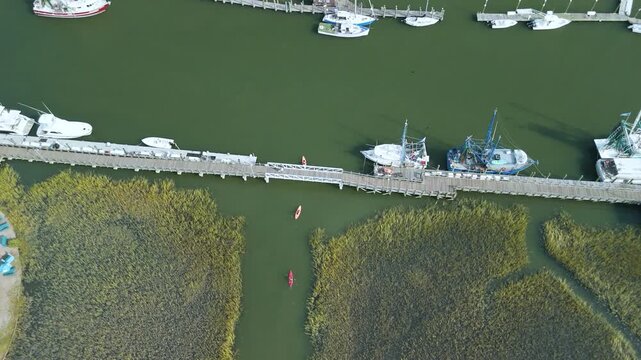 Aerial shot of 3 kayakers , kayaking in lowland marsh in charleston sc