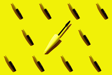 Pattern on yellow background, black mascara.