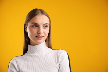 Portrait of confident woman on yellow background. Space for text