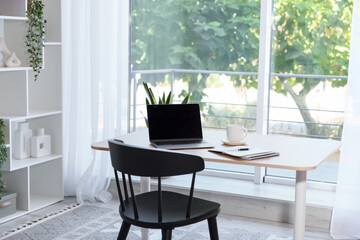 Home workspace. Modern laptop and stationery on wooden desk indoors