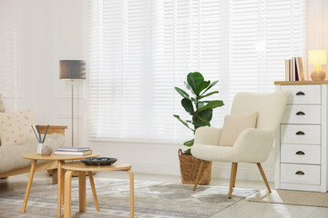 Stylish living room with lamp, houseplant and sofa. Interior design