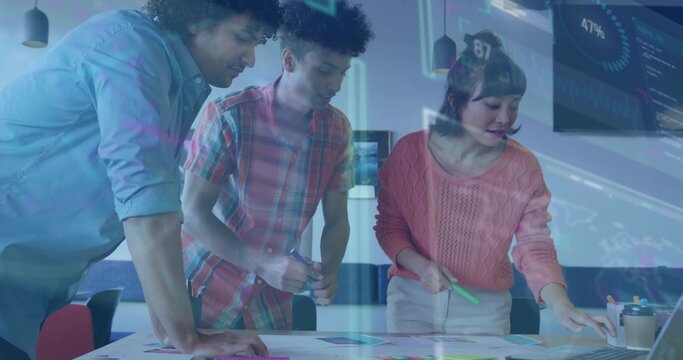 Collaborating team members analyzing data at meeting room table, with laptop charts overlay