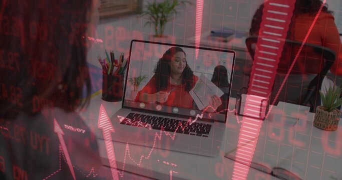 Showing woman presenting notepad on laptop in home office with financial overlay, monitor on desk - Powered by Adobe