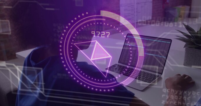 Woman in hoodie monitoring laptop charts in office, showing purple envelope icon with floating code - Powered by Adobe