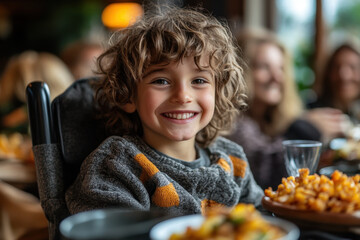 Young boy smiling while eating at a restaurant.