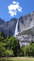 Majestic waterfall cascading down granite cliffs