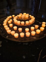 Votive candles glowing in a dark chapel