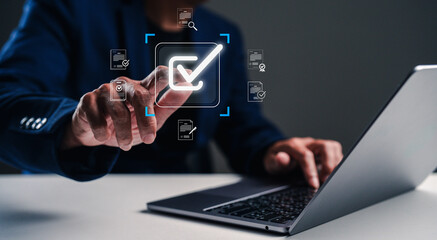 A person interacts with a digital interface, showcasing technology and data management through a laptop and smartphone.