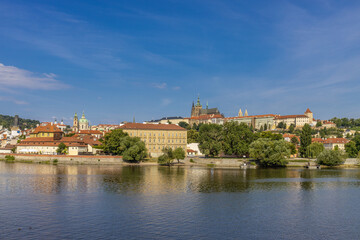 Fototapeta premium Prague cityscape, the capital of Czech Republic tourist sights. Prague historic center district at Charles bridge during the day. Busy tourist area city sights of Prague, capital of Czech