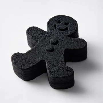 Charcoal Gingerbread Man Cookie on a White Background.