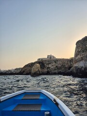 Boat near a cave in the coast on Sicily Italy