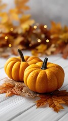 Bright orange and white pumpkins are surrounded by vibrant autumn leaves, creating a festive and cozy fall atmosphere indoors