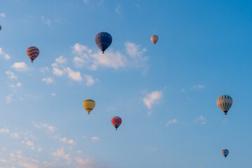 Three hot air balloons against a blue sky. Beautiful view of colourful hot air balloons from below. Cappadocia
